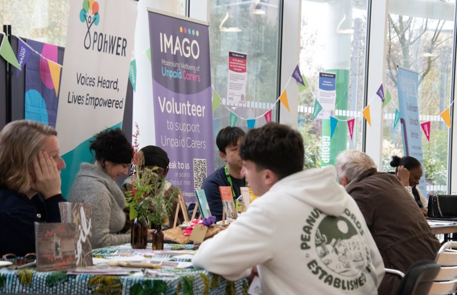 people chatting at an information day. Stall holders visible in Imago and Pohwer